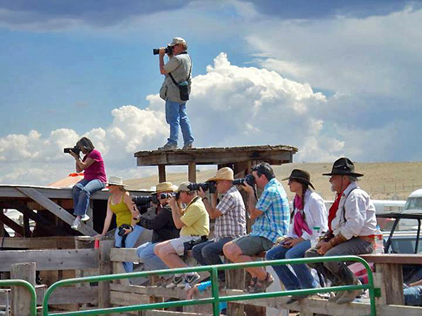 Gene Peach photographing at the rodeo